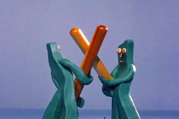 Two gumbys dueling with hot dog swords